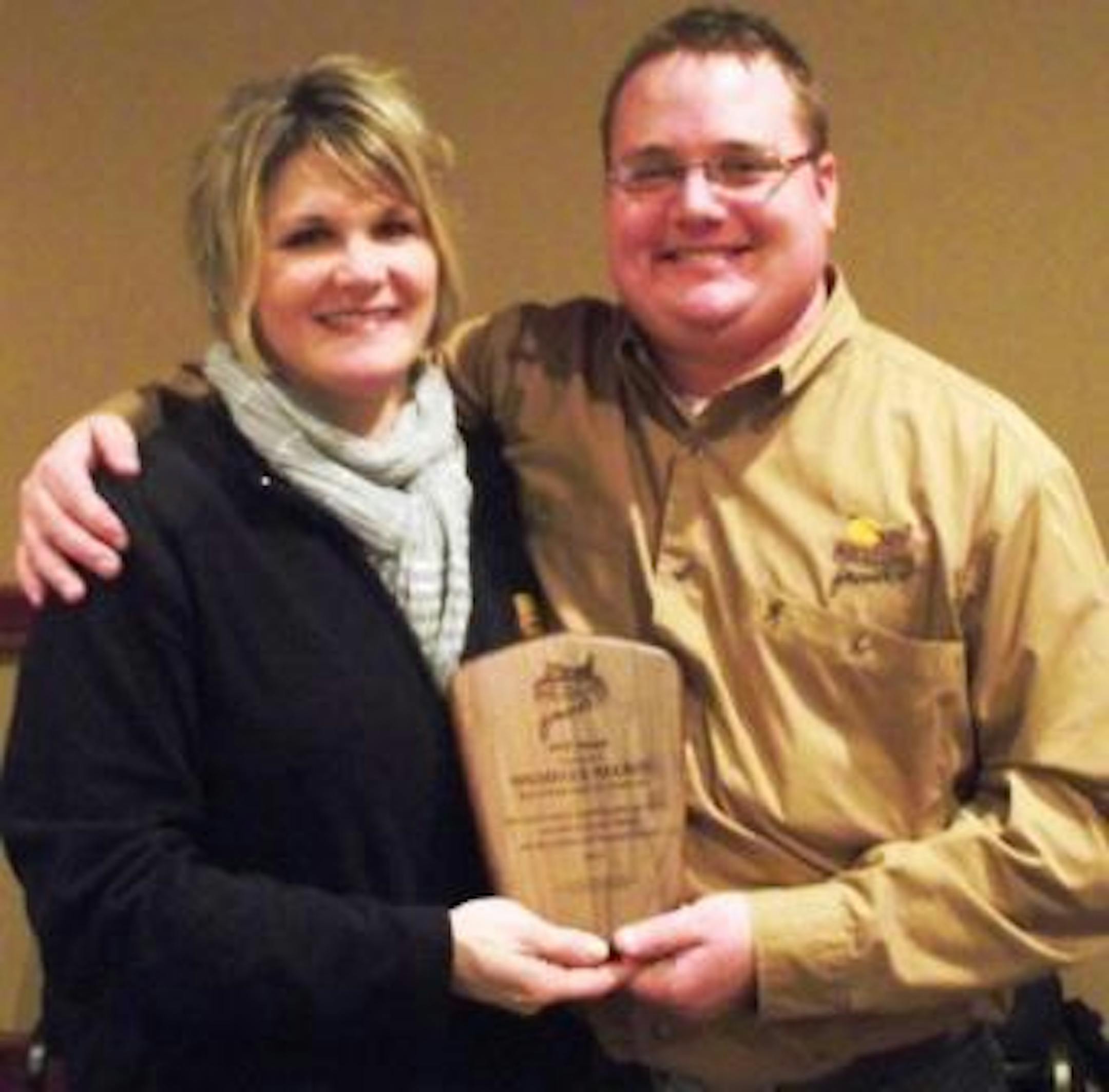 Michelle Nelson receives the North Dakota Pheasants Forever MVP Award from Jesse Beckers, Pheasants Forever Regional Wildlife Biologist.