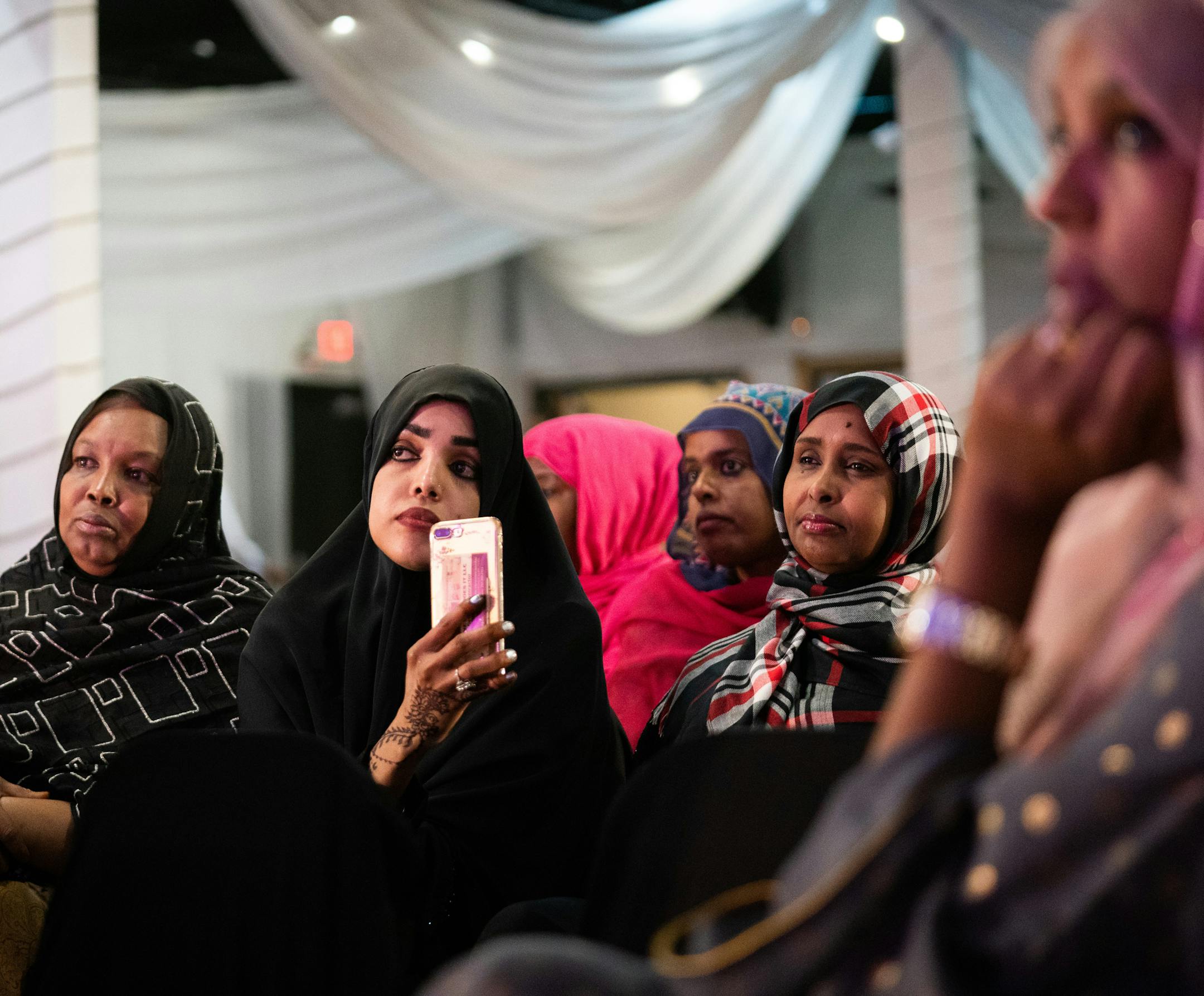 Munira Mohmed (center) and Habiba Mohamed (right) listened as speakers shared memories of slain journalist Hodan Nalayeh and her work. Munira Mohmed met Nalayeh during her last visit to Minneapolis and remembered her ability to inspire the Somali diaspora to make change in their homeland. ] MARK VANCLEAVE ¥ Members of the Twin Cities Somali community gathered to remember Somali-Canadian journalist Hodan Nalayeh at Safari restaurant in Minneapolis on Monday, Jul 15, 2019. Nalayeh and her hus