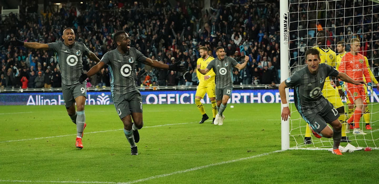 Minnesota United midfielder Ethan Finlay (13, right) celebrated after scoring a goal in the second half as midfielder Kevin Molino (7) and forward Angelo Rodriguez (9) ran toward him to congratulate him.