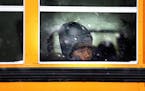 A child rode a bus to school in St. Paul during the first snowstorm of the season in November 2014.