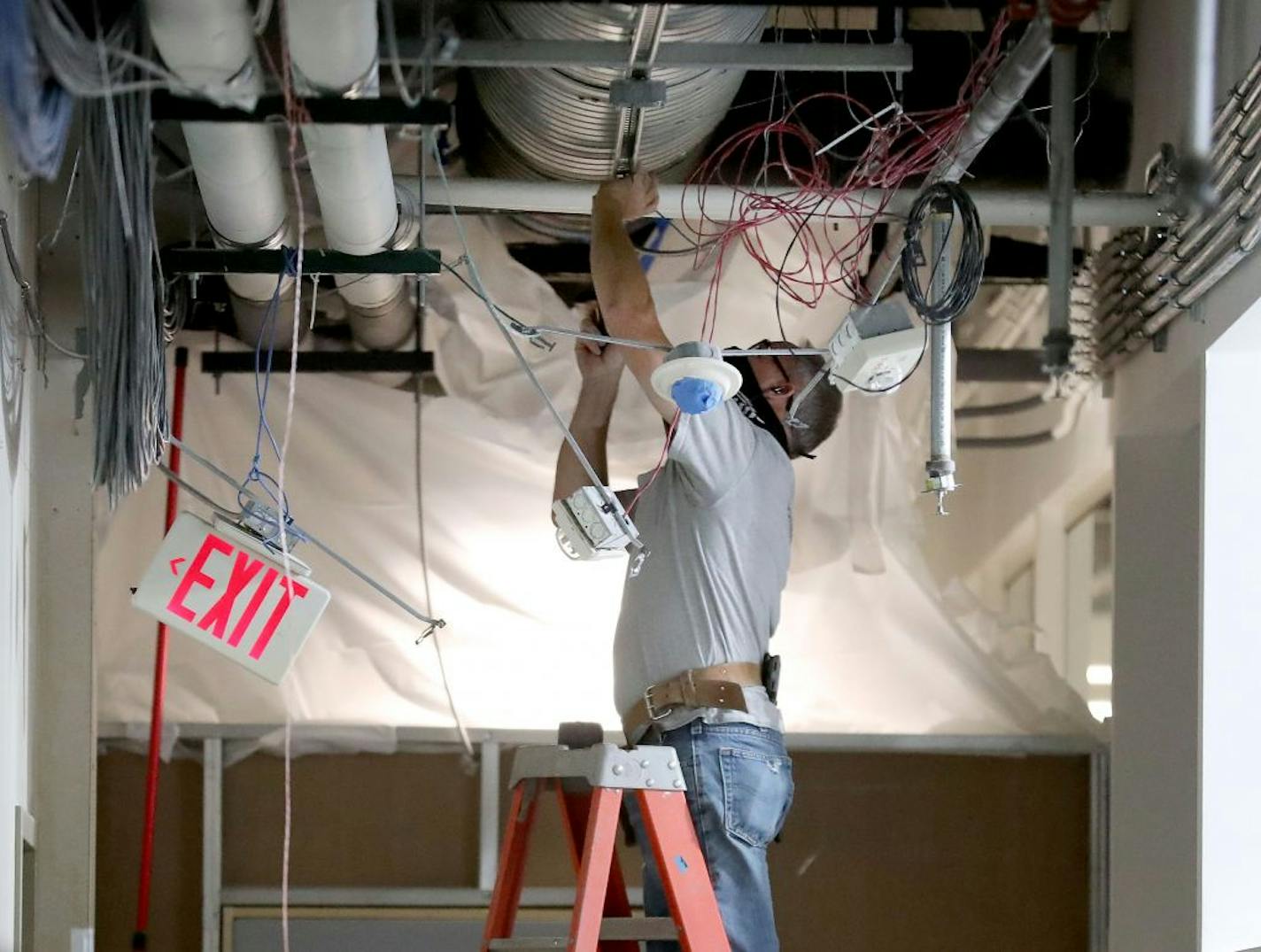 James McNamara, an electrician at Collins Electrical Construction Co., worked on a corridor for lighting fixtures, at Delta Dental Minnesota's corporate offices and seen Thursday in Minneapolis.