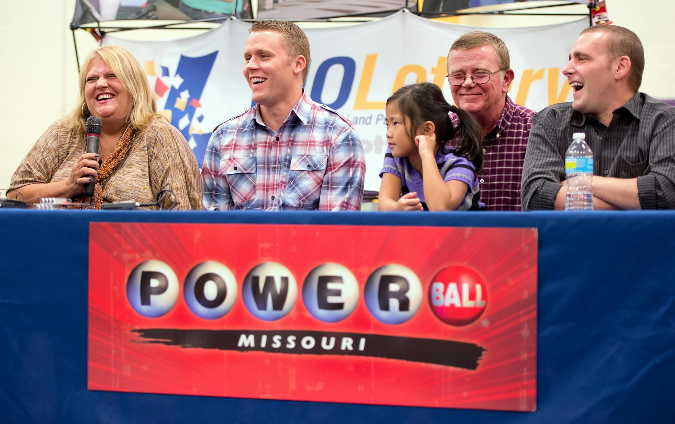 Cindy Hill, left, with her son Jason, daughter Jaiden, husband Mark Hill, second from right, and son Cody, right, laugh during the news conference, Friday, November 30, 2012, at North Platte High School in Dearborn, Missouri, after the family claimed $293,750,000 as co-winners in the Powerball lottery jackpot.
