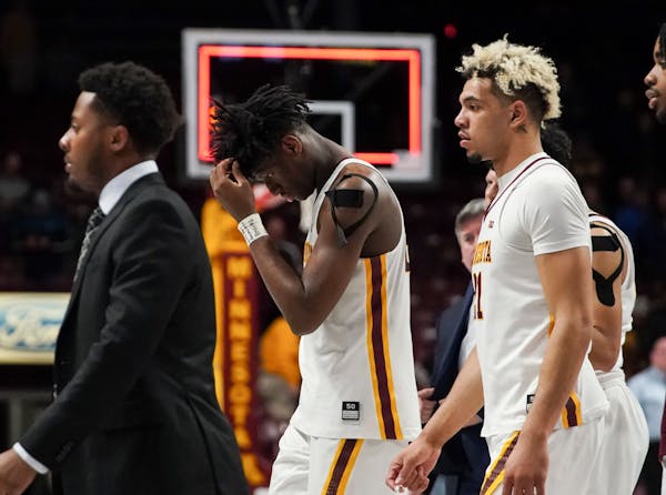 Gophers center Daniel Oturu walked off the court with his head down after a hard loss to Maryland