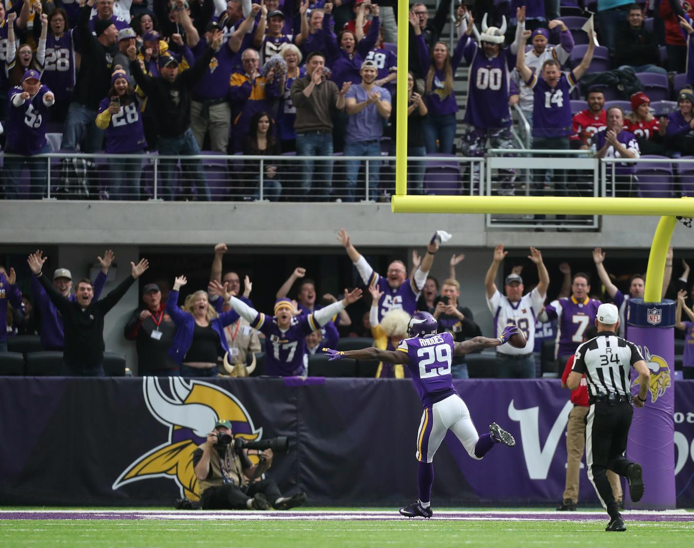 Vikings cornerback Xavier Rhodes celebrated as he entered the end zone after a record 100-yard interception return in the second quarter against the Cardinals on Sunday.