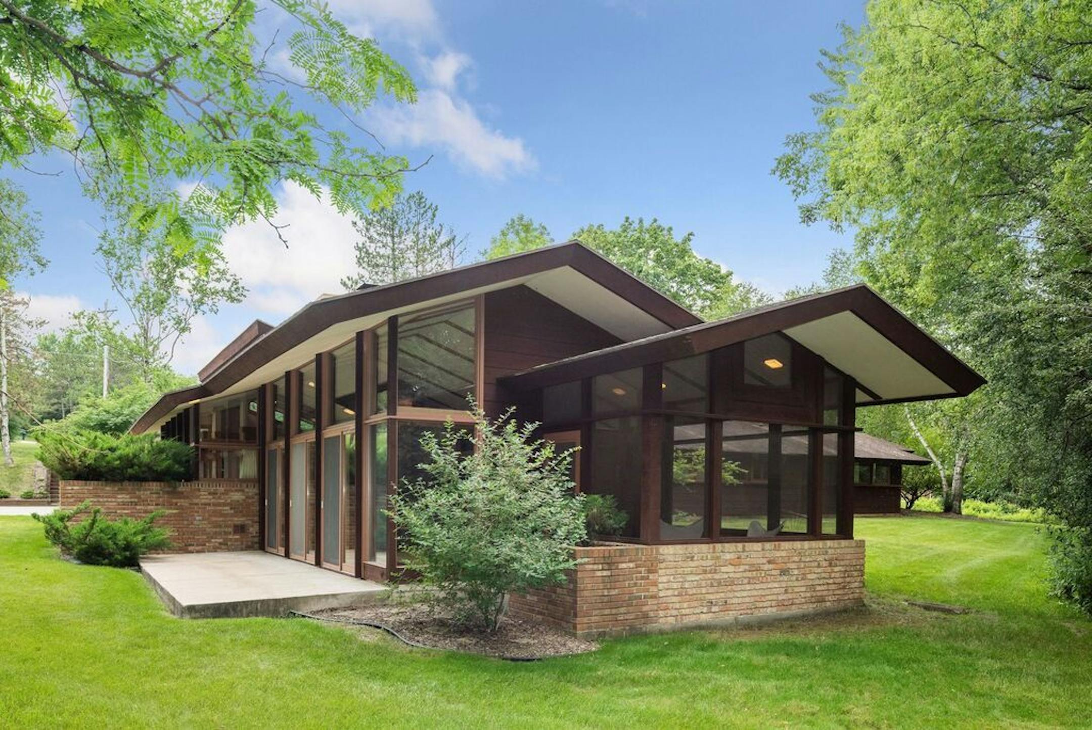 The back of the house walls of glass overlooking its 2-plus-acre site.