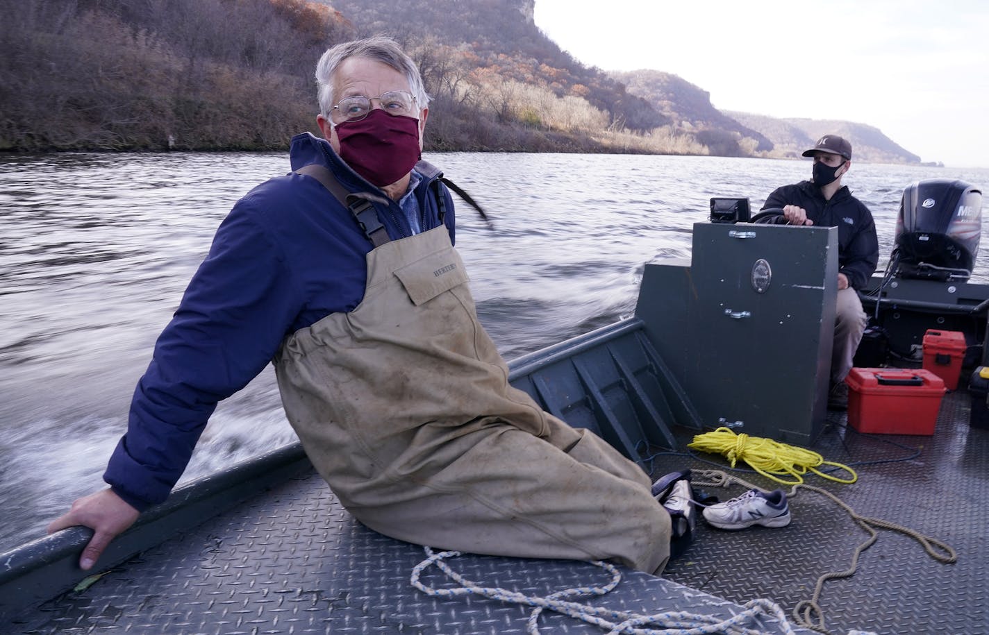 Peter Sorensen sat against the hull of his boat as Jeff Whitty, a research biologist, steered them down the Mississippi River towards their target area of study near Lock and Dam 5.