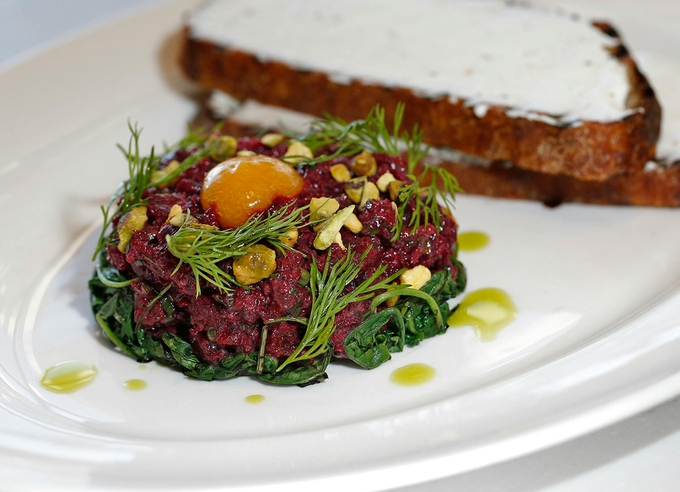 Beet Tartare, dish of of Bellecour BEET TARTARE
salt roasted beets, whipped chèvre, pistachio, grilled arugula.