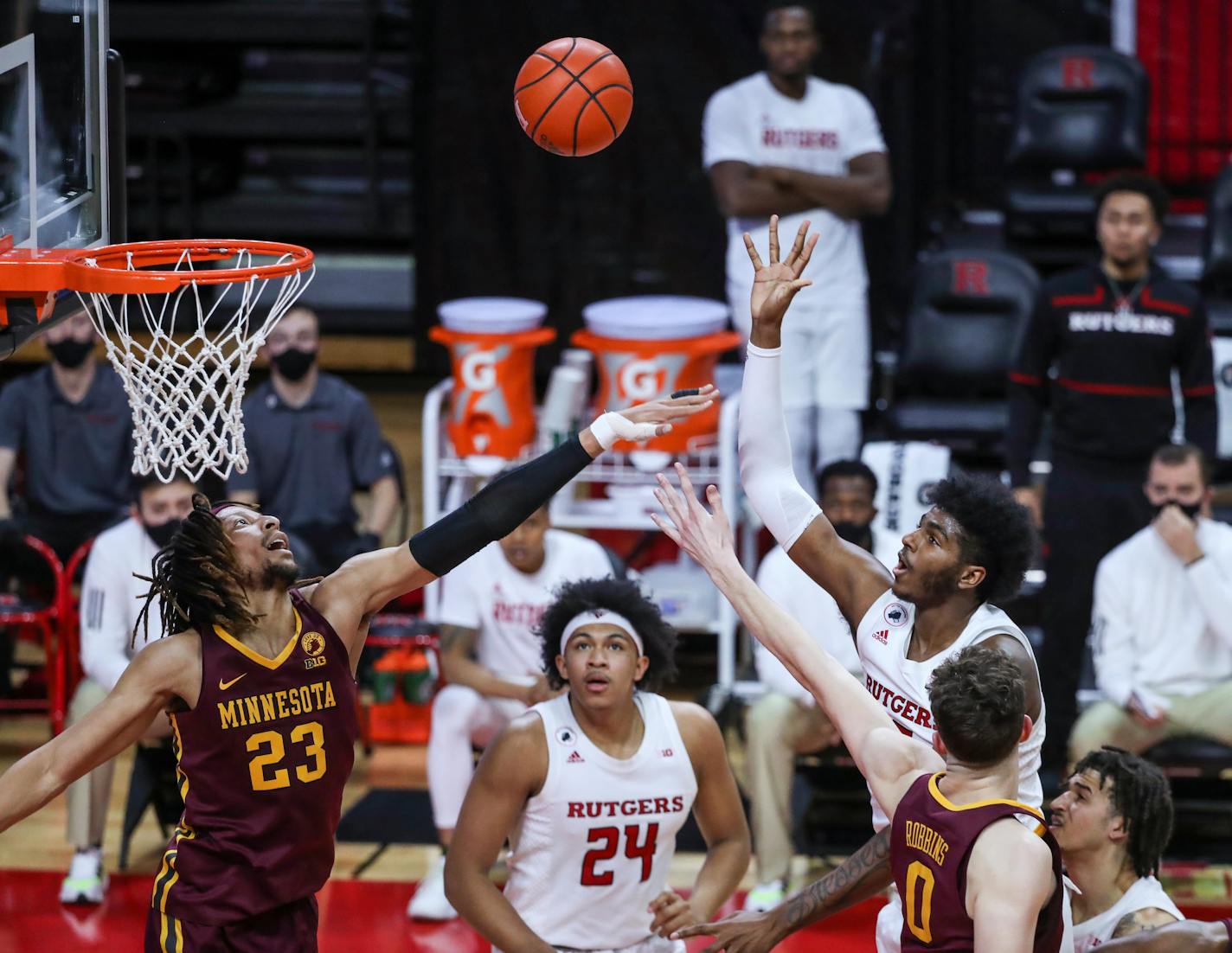 Rutgers center Myles Johnson shoots over the Gophers' Brandon Johnson and Liam Robbins Thursday night in New Jersey.