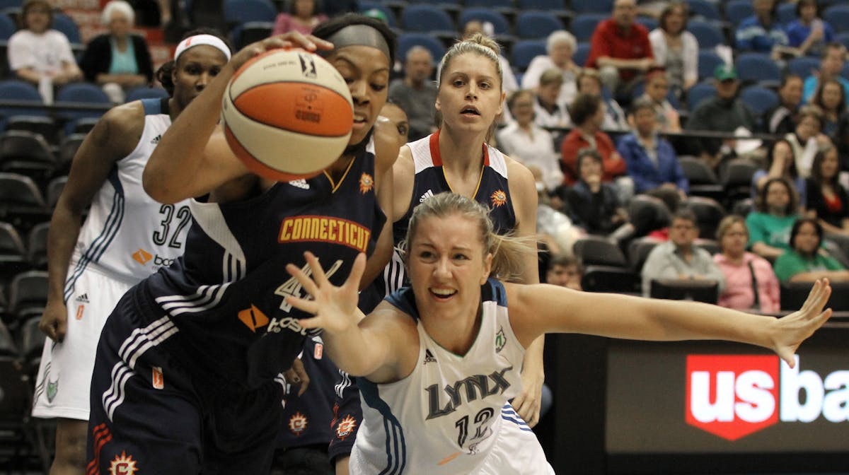 The Sun's Ashley Walker pulled in a loose ball as Lynx's Rachel Jarry dove for it.