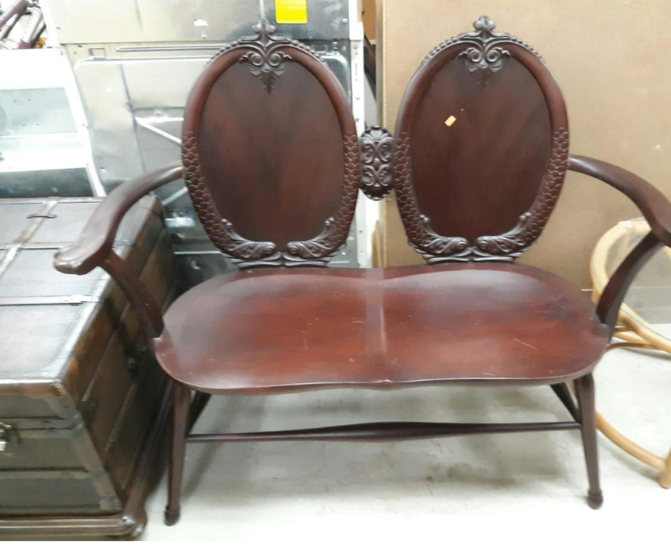 The oval backs on this circa 1900 settee are enclosed with dolphins. (Handout/TNS)