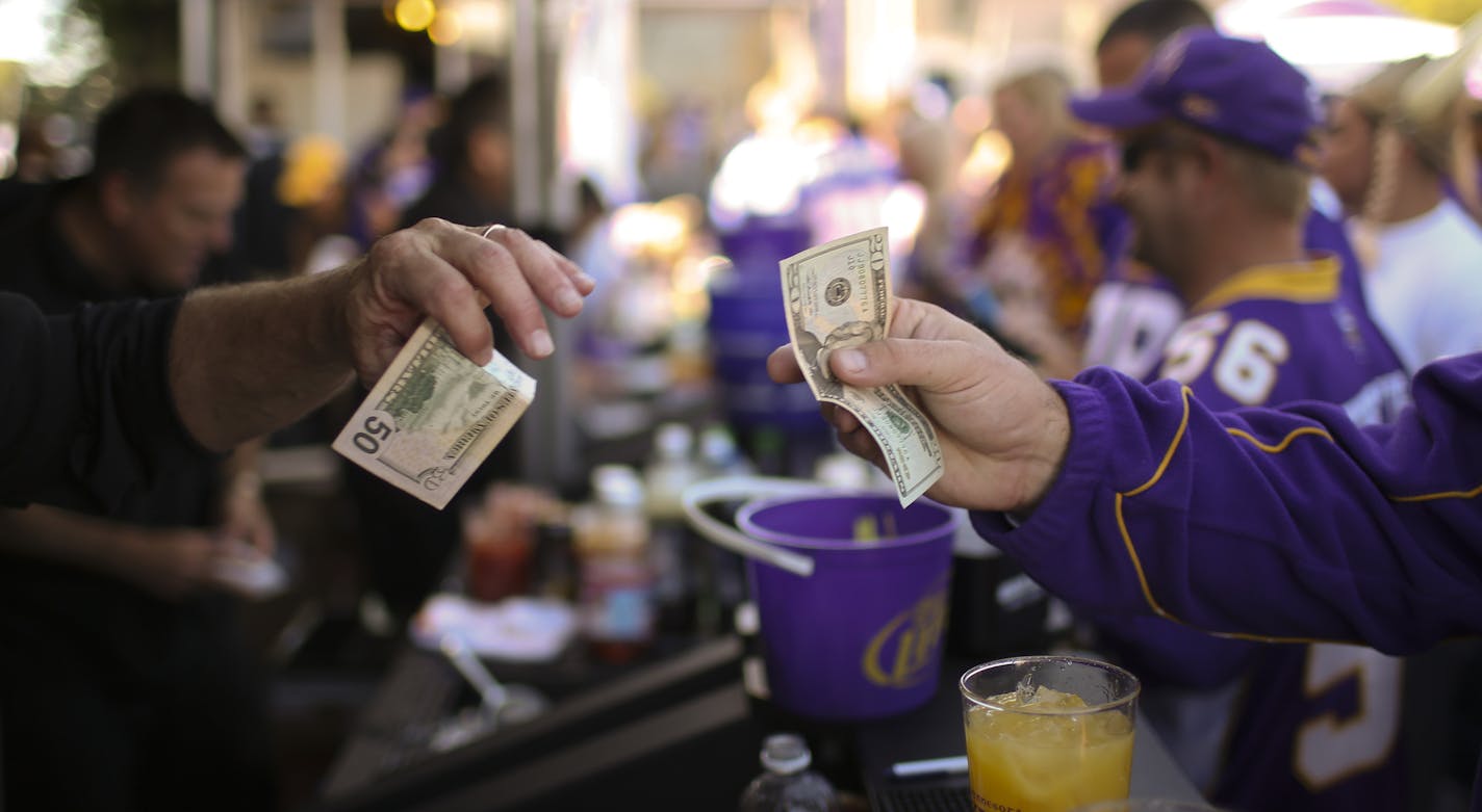 The Minnesota Vikings remained winless after their 31-27 loss to Cleveland Browns in their home opener Sunday afternoon, September 22, 2013 at Mall of America Field in Minneapolis. Their game next weekend in London will result in a drop in revenue for vendors who depend on fans' spending at home games. A bartender took payment from a customer for drinks at a bar right outside the Metrodome before Sunday's Vikings game. ] JEFF WHEELER &#x201a;&#xc4;&#xa2; jeff.wheeler@startribune.com