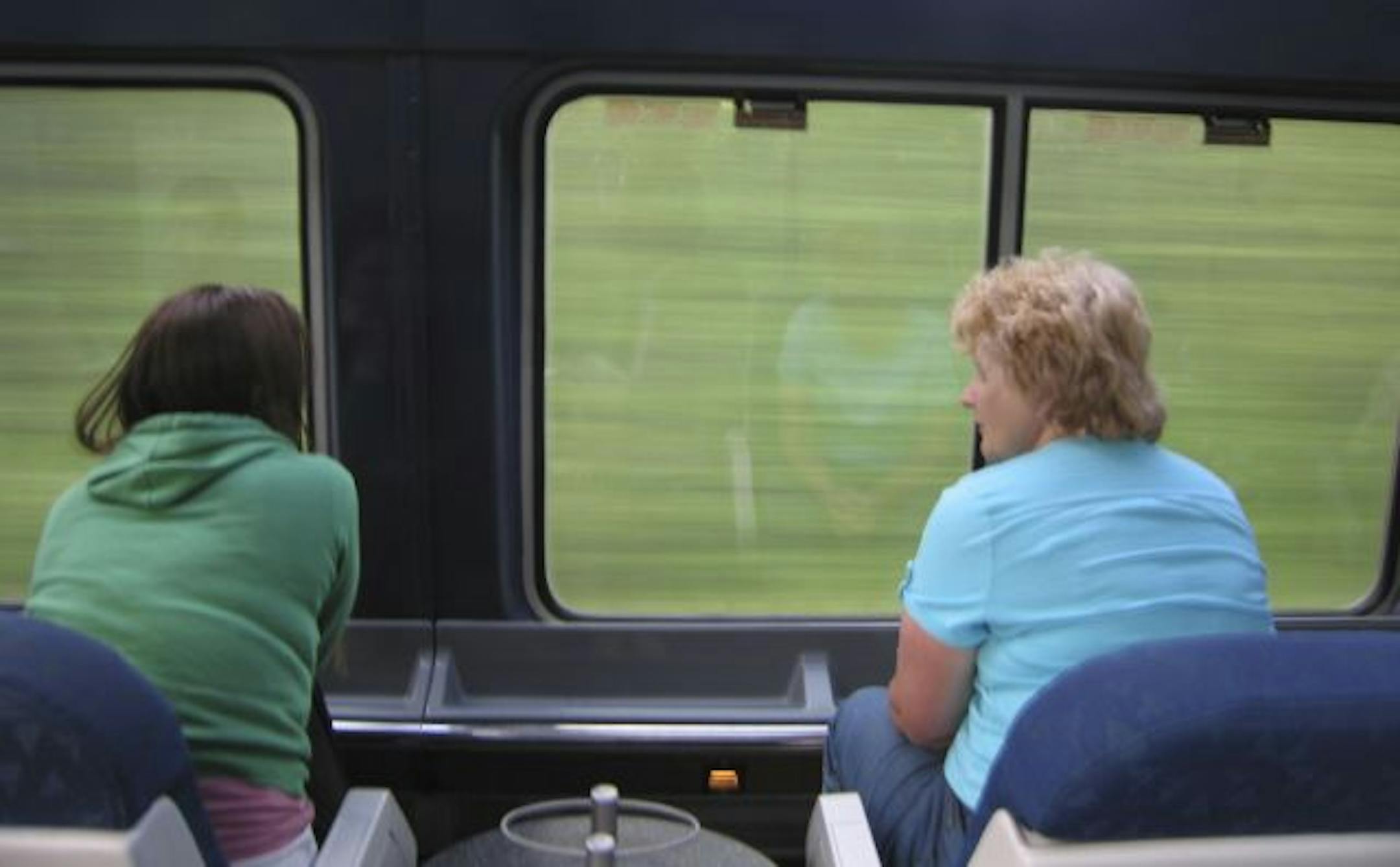 Passengers aboard Amtrak's Empire Builder take in the sights from the observation car.