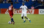 Minnesota United defender Lawrence Olum (right) defended as FC Dallas midfielder Brandon Servania tried to advance the ball during the second half of 