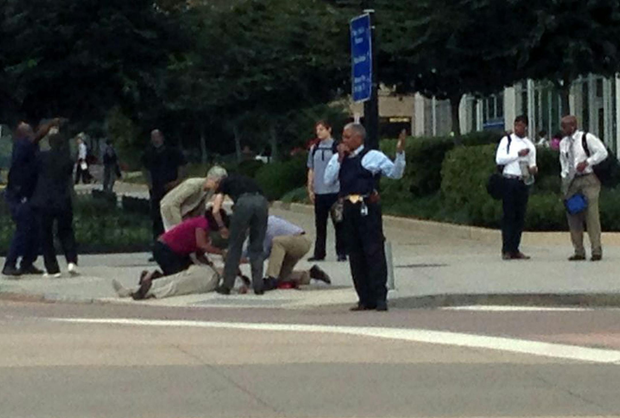 Emergency personnel attend to a scene where a gunman was reported at the Washington Navy Yard in Washington, on Monday, Sept. 16, 2013.