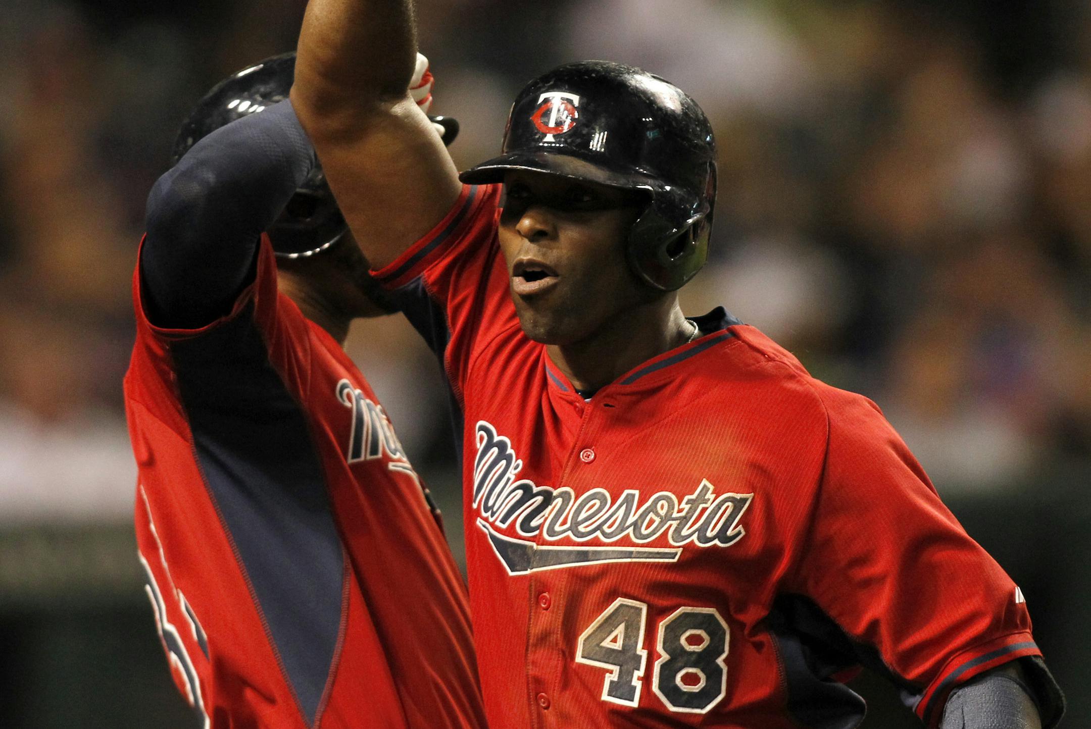 Minnesota Twins Tori Hunter (48) celebrates with teammate Aaron Hicks after hitting a go-ahead solo home run in the ninth inning of a baseball game against the Cleveland Indians, Friday, Aug. 7, 2015, in Cleveland. (AP Photo/Aaron Josefczyk