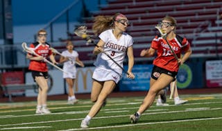 Maple Grove’s Audrey Mlekoday found room to run against Centennial on Thursday at Maple Grove, and Anna Jarpey worked to close the gap. Maple Grove 