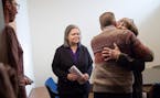 Rep. Karen Clark got a hug from State Senator Scott Dibble moments before she and Rep. Susan Allen entered a press conference to announce their retire