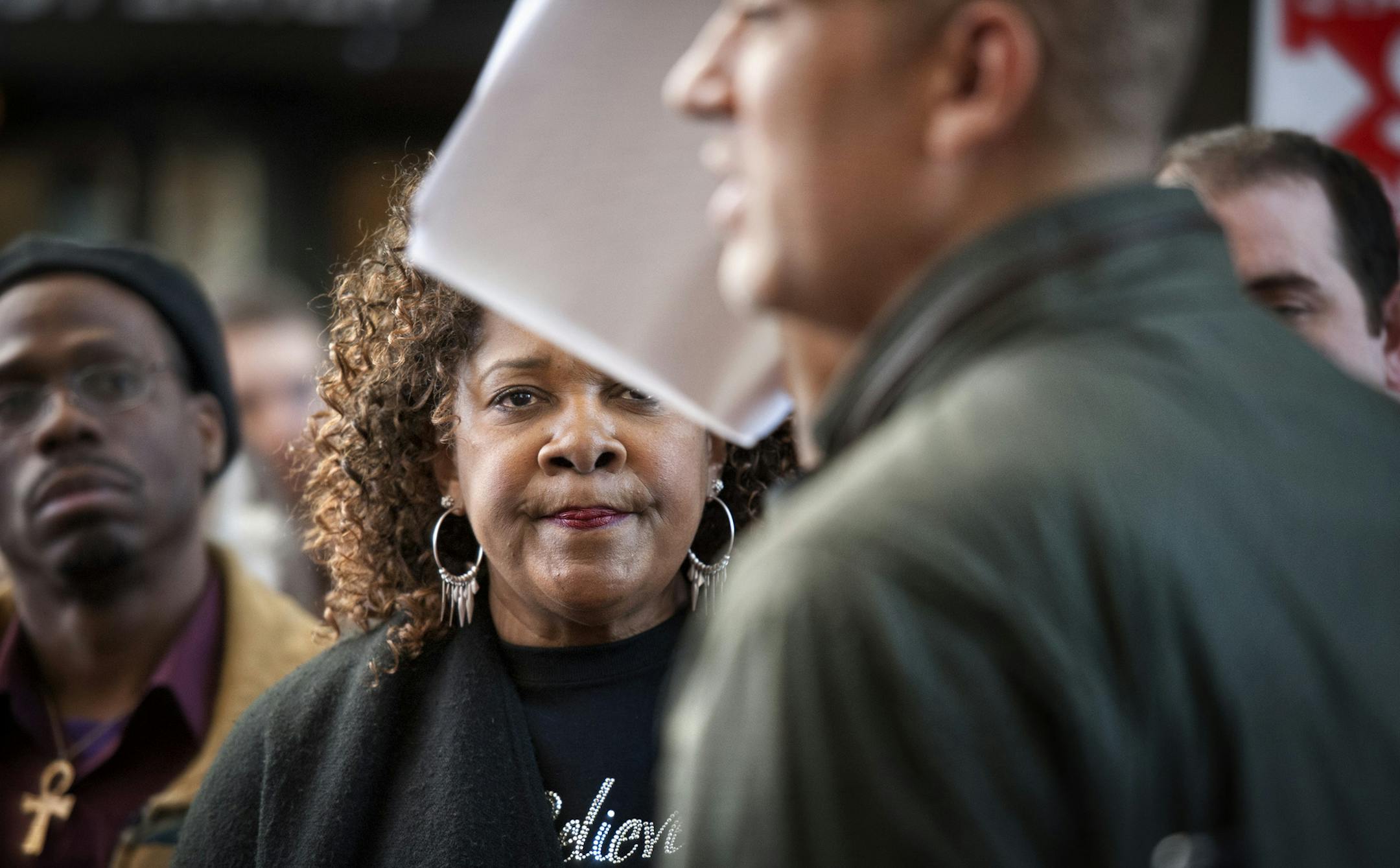 Rose McGee looked on as supporter Anthony Newby waved the petitions he was about to deliver to the U.S. Attorney to Minnesota before Rose headed upstairs to her court hearing. Housing activists marched a petition with about 330,000 signatures to U.S. Department of Justice offices across the country on Tuesday, calling on President Barak Obama to break up the big banks and prosecute their executives. The petition, signed by an estimated 2,600 Minnesotans, was headed to the Minneapolis office of B