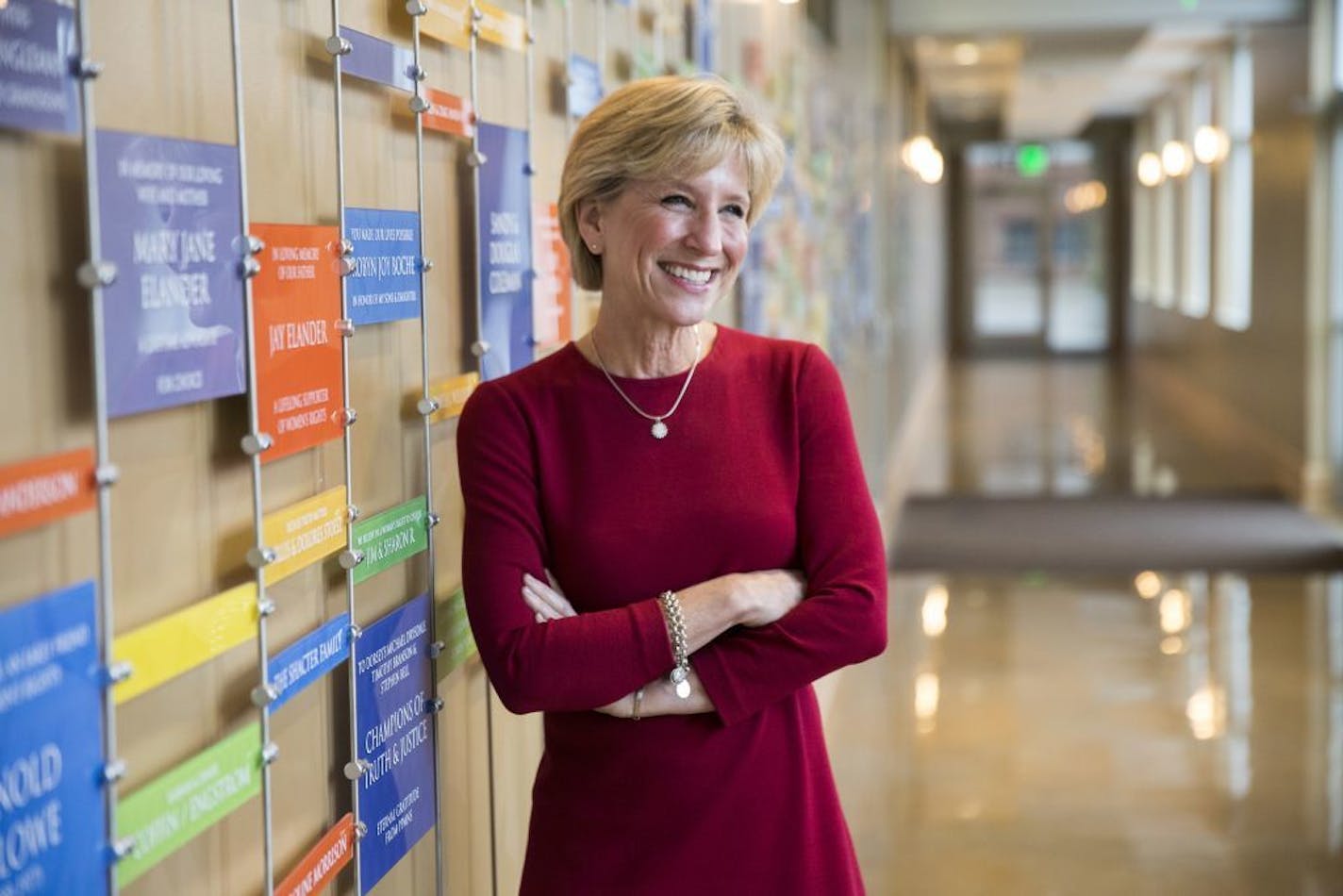 Sarah Stoesz, president and CEO of Planned Parenthood Minnesota, South Dakota and North Dakota, poses next to the donor wall in the organization's St. Paul headquarters.