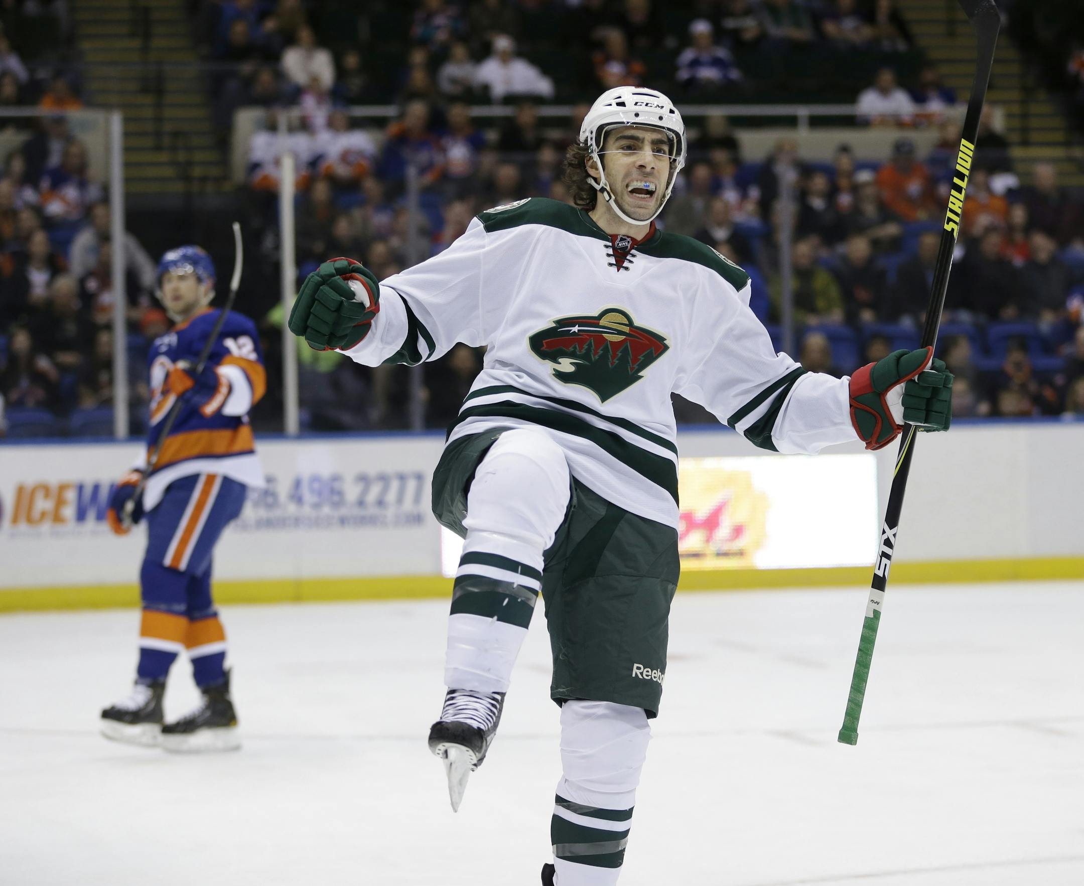 Minnesota Wild's Matt Moulson celebrates after scoring during the first period of the NHL hockey game against the New York Islanders, Tuesday, March 18, 2014, in Uniondale, New York. (AP Photo/Seth Wenig)