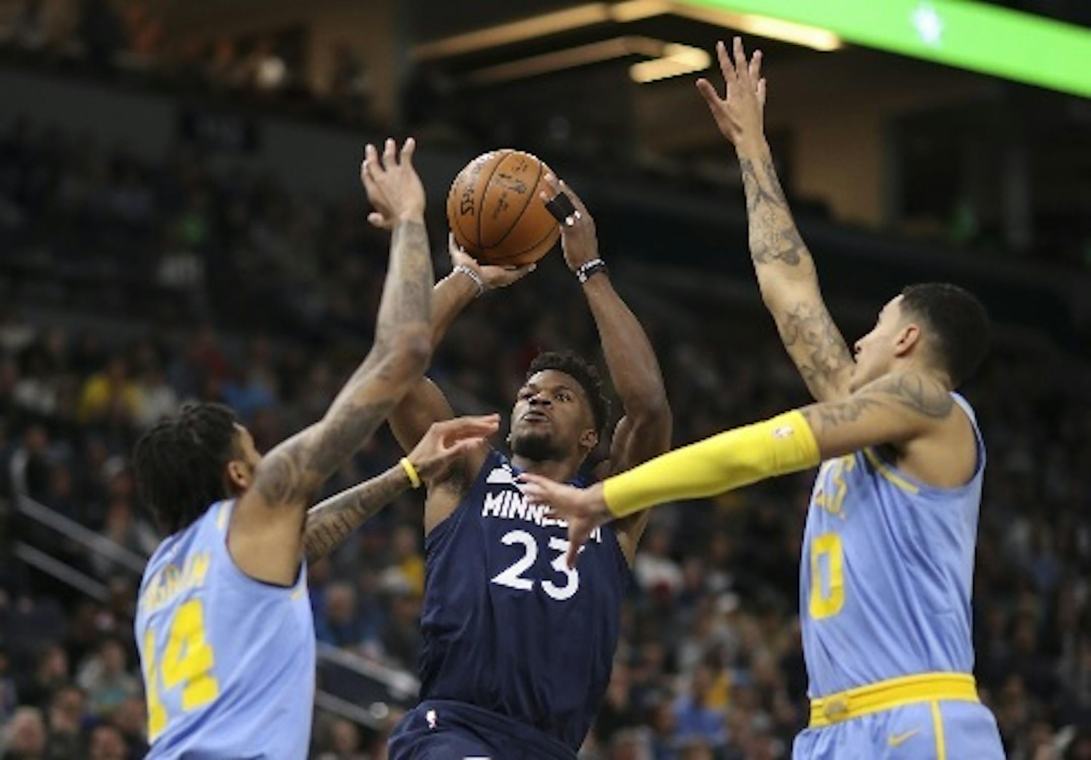 Wolves guard Jimmy Butler put up a first-quarter shot between Lakers forwards Brandon Ingram (14) and Kyle Kuzma at Target Center on Monday night. Butler led all scorers with 28 points in the Wolves' 114-96 victory.