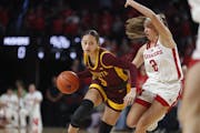 The Gophers' Amaya Battle (3) attempted to get past Nebraska's Logan Nissley (2) on Saturday in Lincoln, Neb.