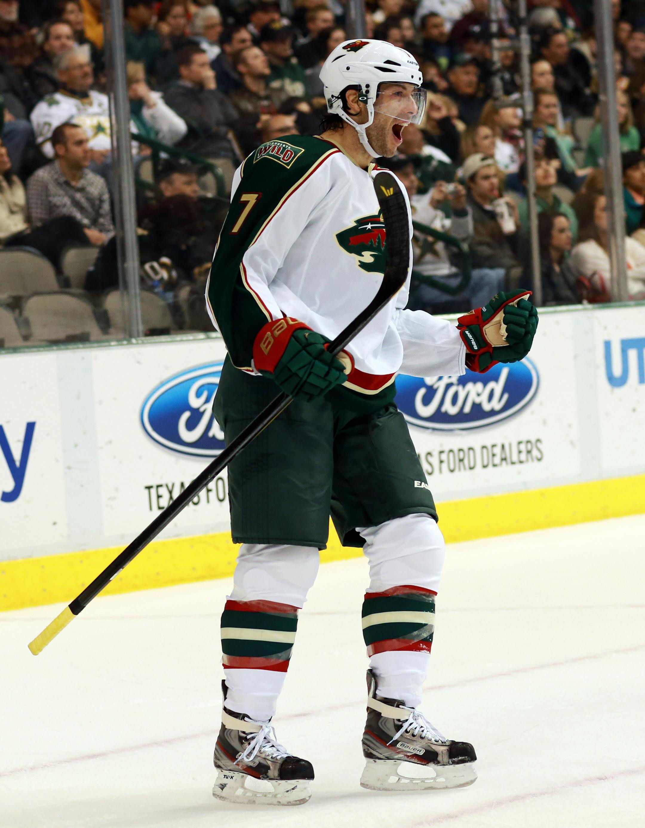Minnesota Wild center Matt Cullen (7) celebrates his go-ahead goal on Dallas Stars goalie Kari Lehtonen during the second period of an NHL hockey game Monday, March 25, 2013 in Dallas. (AP Photo/ Michael Mulvey) ORG XMIT: MIN2013032522185471
