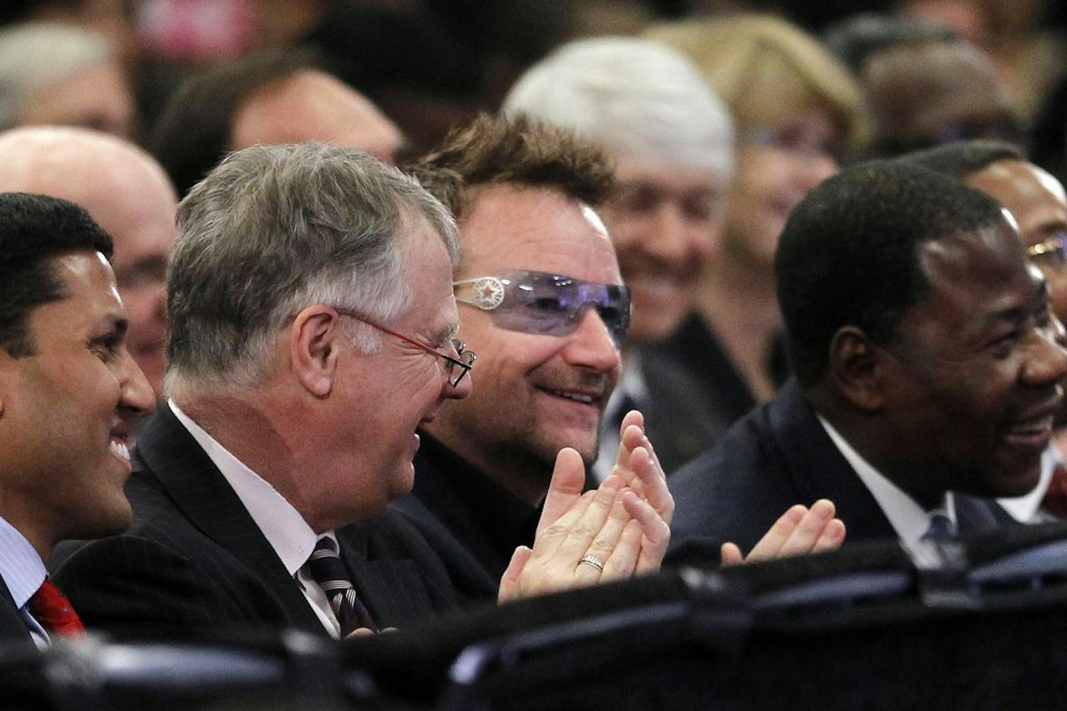 U2 lead singer, Bono, center, sits in the front row as he listens to President Barack Obama speak at the Symposium on Global Agriculture and Food Security at the Chicago Council on Global Affairs, Friday, May 18, 2012, at the Ronald Reagan Building in Washington.