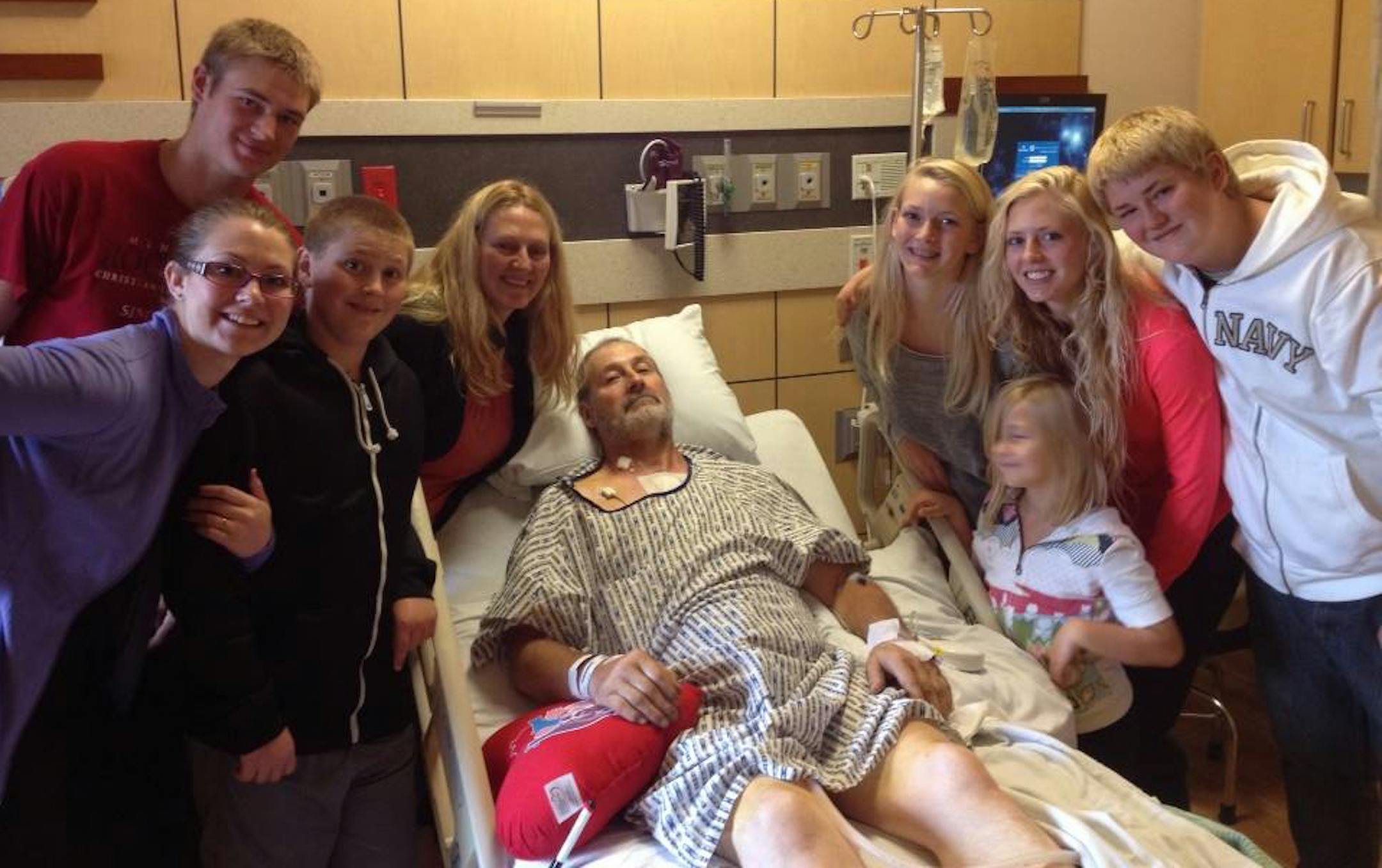 Eugene Rakow, with his family after having a nail removed from his heart.