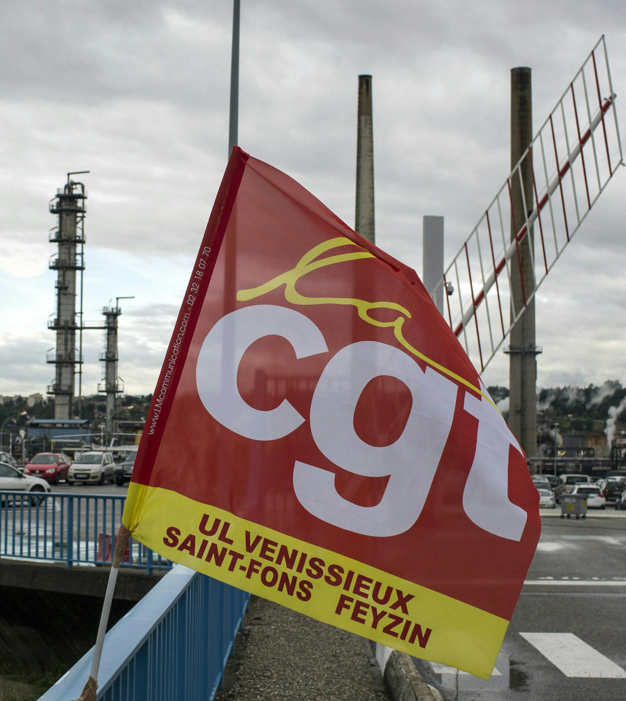 A CGT union flag flutters at the main entrance of the Feyzin refinery in background, near Lyon, central France, Monday, May 30, 2016. Striking workers have blocked or slowed production at most of France’s eight refineries, and disrupted oil imports at major ports around Marseille and Le Havre. (AP Photo/Laurent Cipriani)