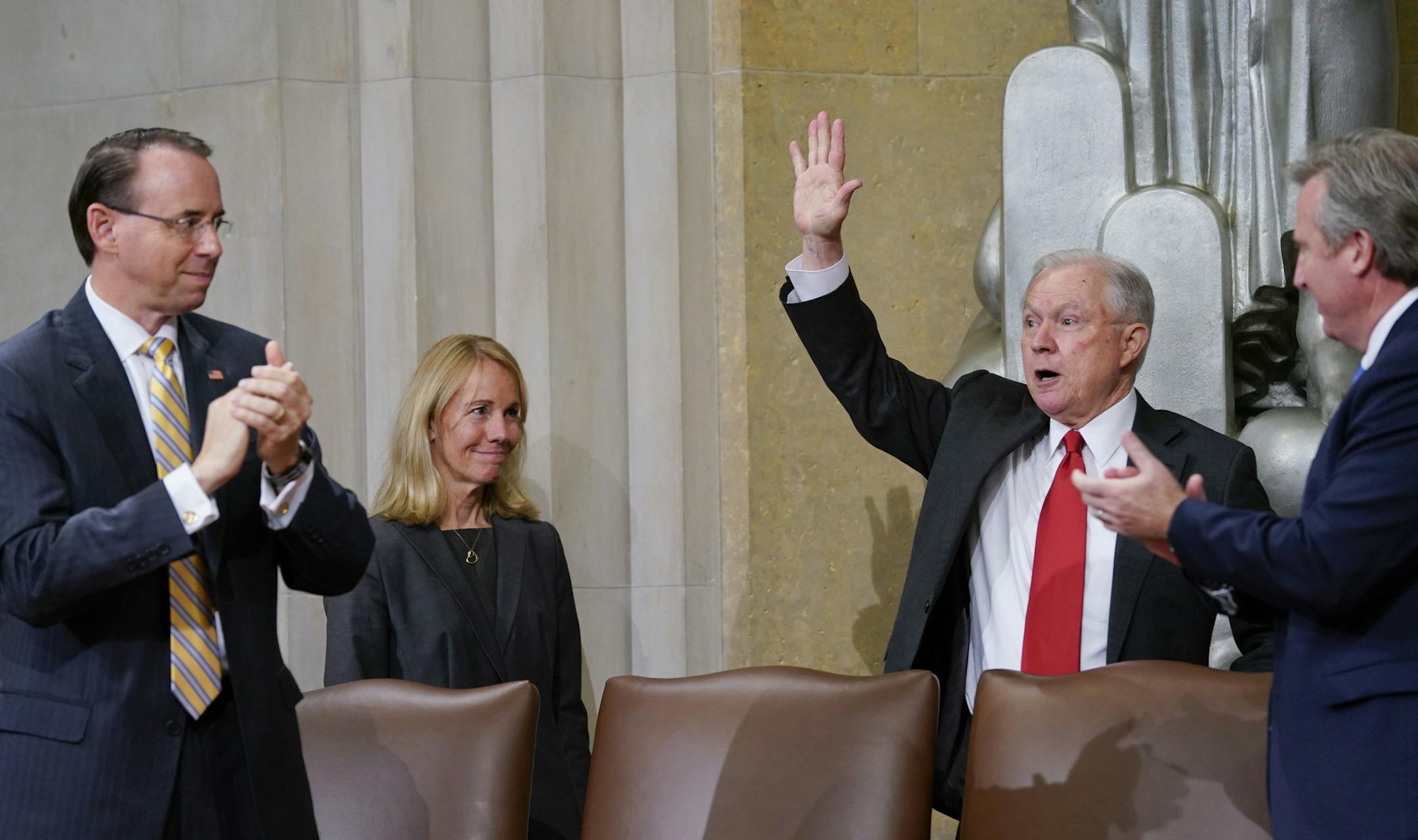 Attorney General Jeff Sessions, right, waves after speaking at the U.S. Marshals Service 37th Director's Honorary Awards Ceremony, at the Department of Justice in Washington, Thursday, Nov. 1, 2018. On the far left is Deputy Attorney General Rod Rosenstein. (AP Photo/Pablo Martinez Monsivais)