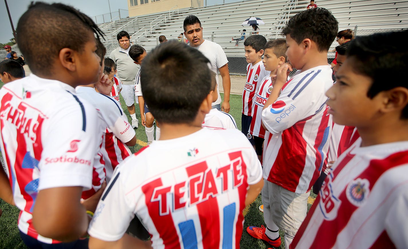 Go team, go: Angel Ramirez Diaz, center, gave his team &#x201c;chivitas,&#x2019;&#x2019; a pep talk, before their Aug. 29 game at Academy of Holy Angels in Richfield. At top, Anna Garcia, left, and Bertha Espinoza, right, cheered their children&#x2019;s team.