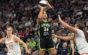 Lynx forward Napheesa Collier (24) scores over the Mercury's Haley Jones in the second quarter at Target Center on Tuesday.
