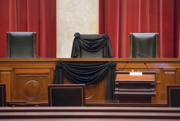 Supreme Court Justice Antonin Scalia's courtroom chair was draped in black Tuesday to mark his death at the Supreme Court in Washington.