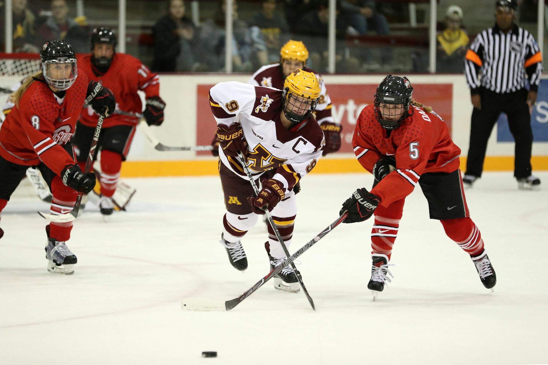 Minnesota Golden Gophers defenseman Sydney Baldwin (9) and Ohio State Buckeyes forward Charly Dahlquist (5) raced for a loose puck in the first period. ] ANTHONY SOUFFLE • anthony.souffle@startribune.com Game action from an NCAA women's ice hockey match between the Minnesota Golden Gophers and the Ohio State Buckeyes Friday, Oct. 6, 2017 at Ridder Arena in Minneapolis. ORG XMIT: MIN1710062012240697
