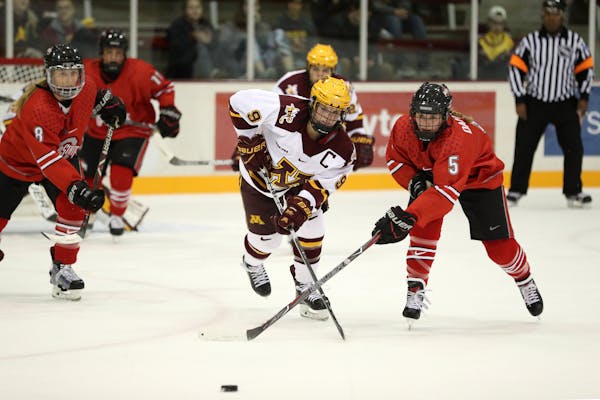 Minnesota Golden Gophers defenseman Sydney Baldwin (9) and Ohio State Buckeyes forward Charly Dahlquist (5) raced for a loose puck in the first period