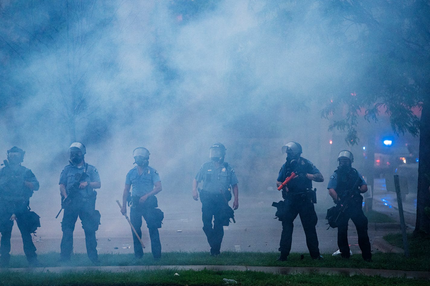 Police officers deploy to disperse protesters gathered for George Floyd in Minneapolis on Tuesday, May 26, 2020. Four Minneapolis officers involved in the arrest of the black man who died in police custody were fired Tuesday, hours after a bystander's video showed an officer kneeling on the handcuffed man's neck, even after he pleaded that he could not breathe and stopped moving. (Richard Tsong-Taatarii/Star Tribune via AP)