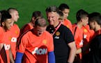 Wayne Rooney, left, manager Louis van Gaal, center, and the rest of Manchester United take on Barcelona on Saturday.