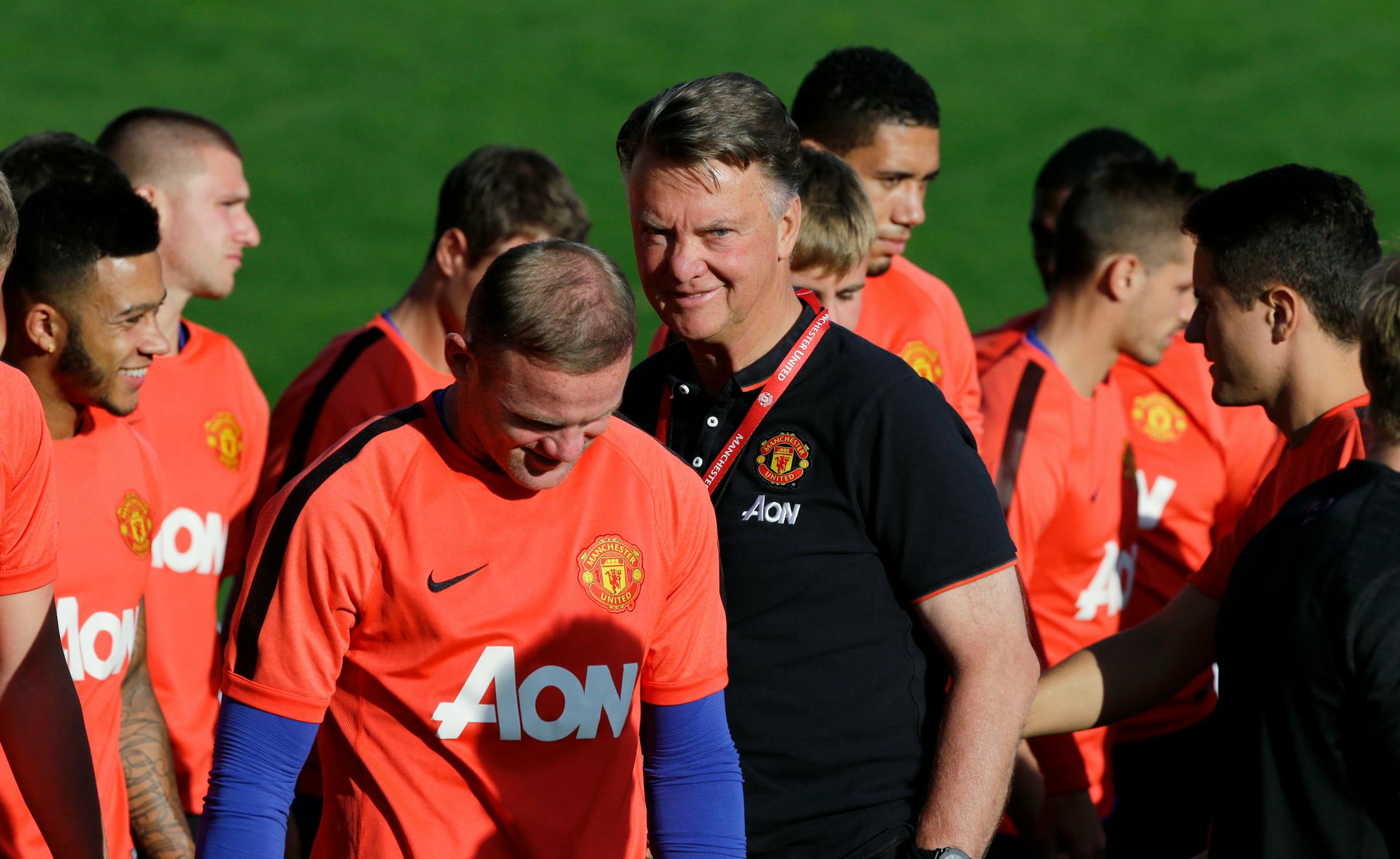 Wayne Rooney, left, manager Louis van Gaal, center, and the rest of Manchester United take on Barcelona on Saturday.
