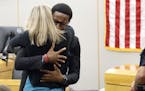 FILE - In this Oct. 2, 2019, file photo, Botham Jean's younger brother Brandt Jean hugs convicted murderer and former Dallas Police Officer Amber Guyg