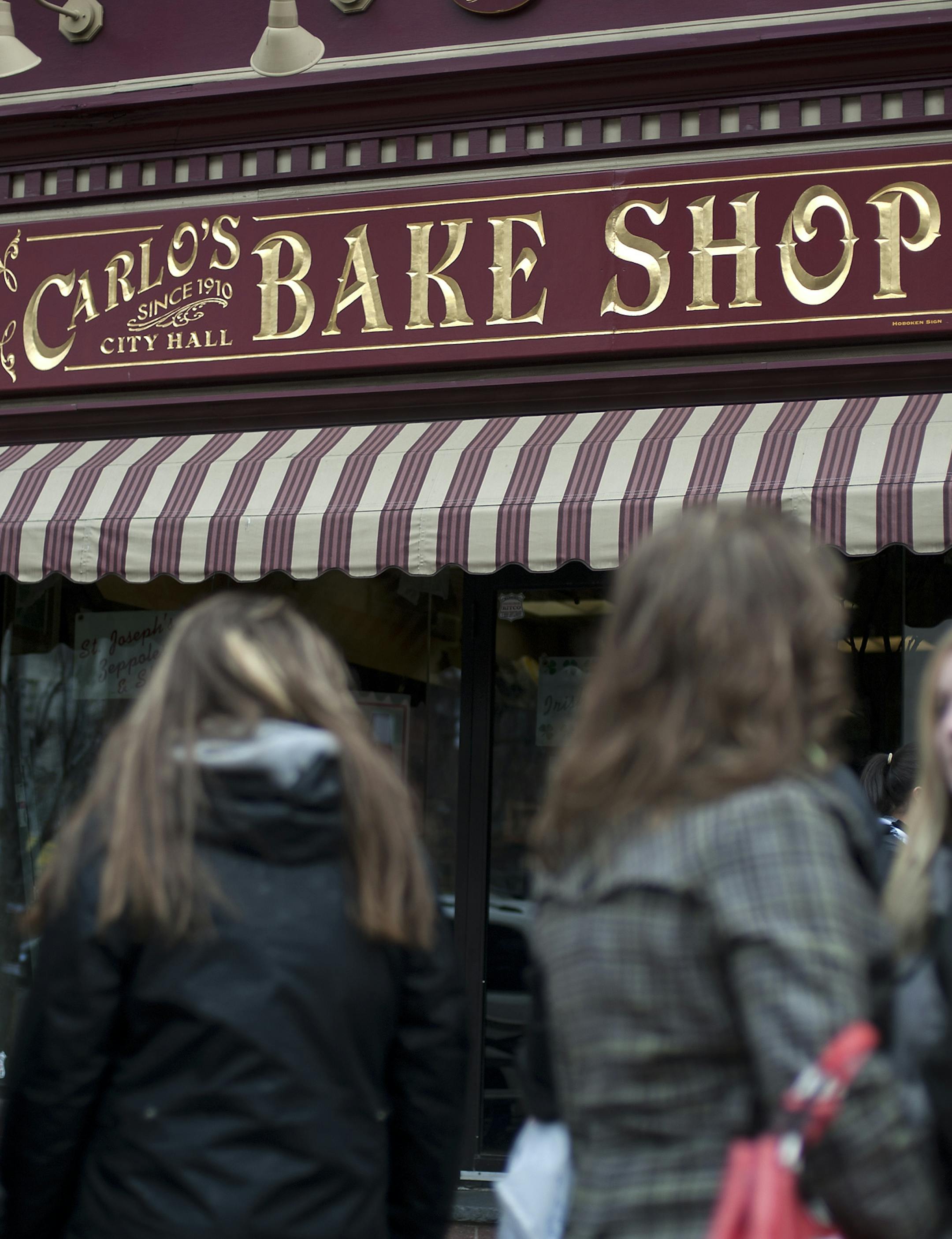 A line outside Carlo's Bakery, owned by Buddy Valastro, the star of TLC&#x2019;s shows "Cake Boss," "Kitchen Boss" and "Cake Boss: Next Great Baker," in Hoboken, New Jersey, March 14, 2011. Valastro is a fourth-generation baker whose father was born on Lipari, an island near Sicily, where the family was so poor they resorted to eating other people's garbage. (Joshua Bright/The New York Times) ORG XMIT: XNYT36
