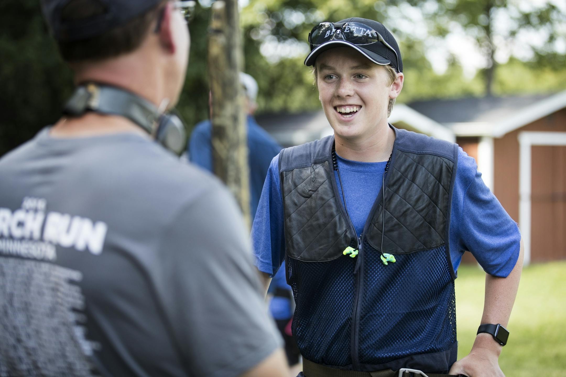Nathan Ziemer, right, 15, of the Wayzata High School Trap Team, talks with Plymouth Police officer Paul Johnson before they begin shooting.