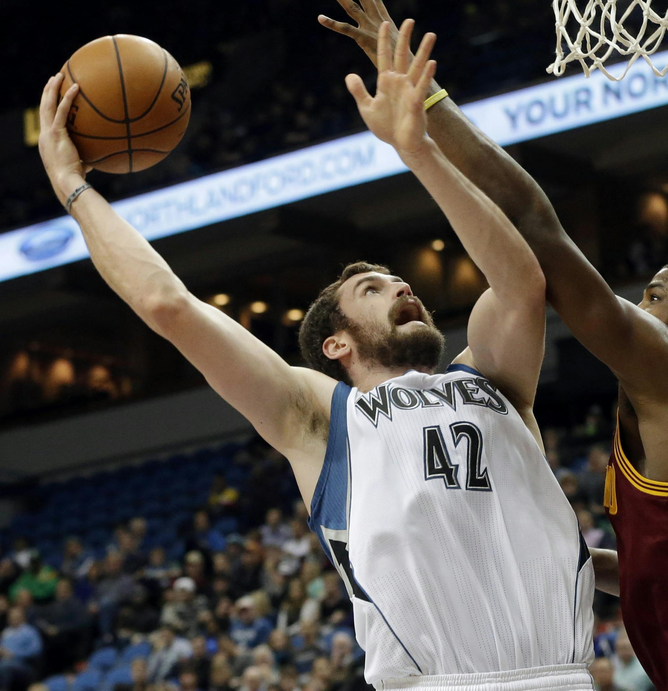 Minnesota Timberwolves' Kevin Love, left, shoots as Cleveland Cavaliers' Tristan Thompson defends in the first quarter of an NBA basketball game Wednesday, Nov. 13, 2013, in Minneapolis. (AP Photo/Jim Mone) ORG XMIT: MNJM103
