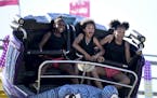 Cousins Alajiah Campbell, 9, Jasoni Bennett, 8, and Kyloni Davenport, 12, of Duluth wore the thrill of the Crazy Mouse spinning roller coaster on thei