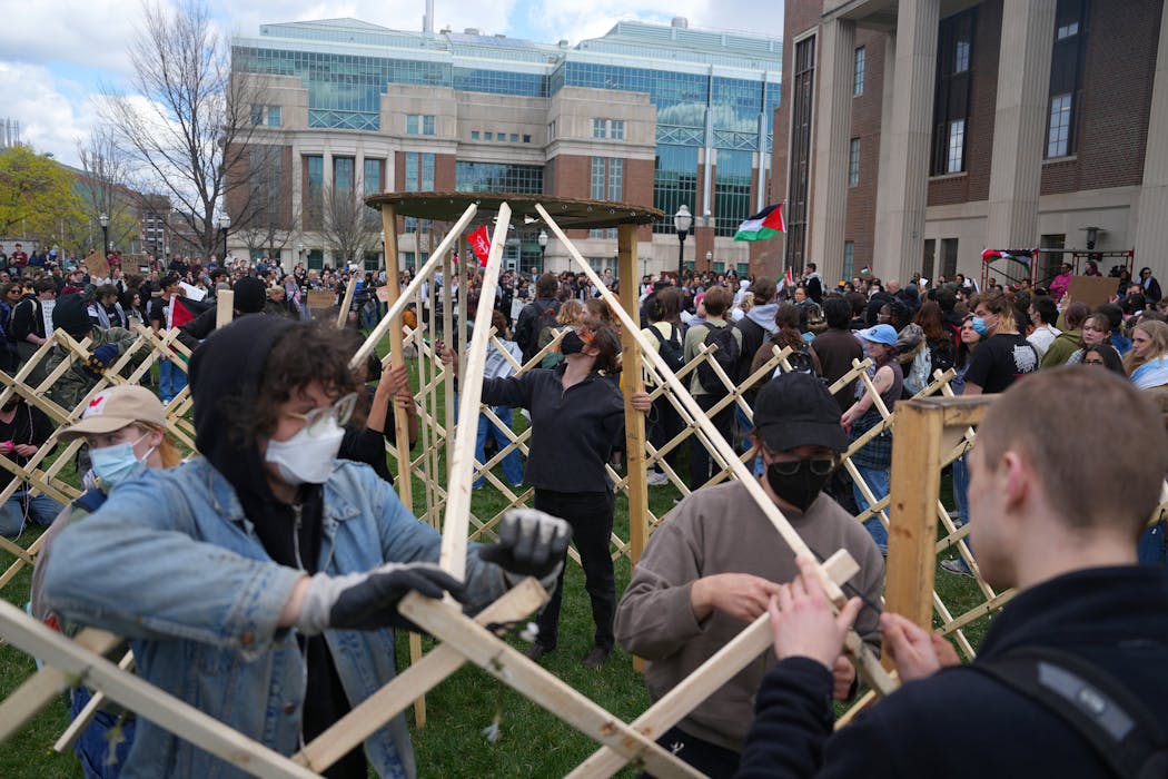 Pro-Palestinian supporters construct yurts during a rally against the latest war between Israel and Hamas. The protest happened hours after the University of Minnesota’s campus police cleared an encampment set up by student groups on Tuesday.