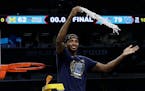 Villanova's Mikal Bridges cuts the net as he celebrates after the championship game of the Final Four NCAA college basketball tournament against Michi