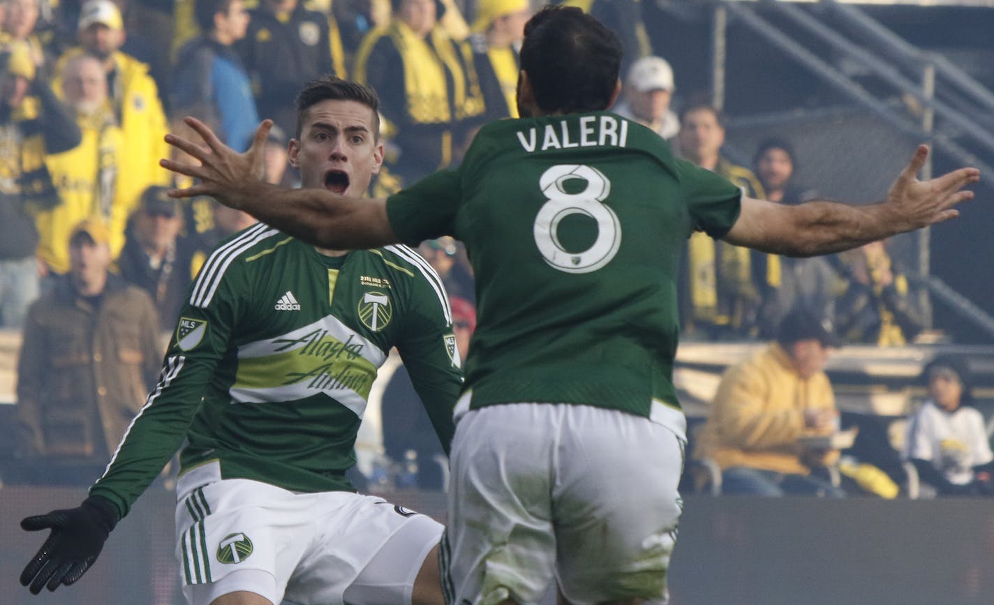 Portland Timbers midfielder Diego Valeri, right, of Argentina, celebrates his goal against the Columbus Crew with teammate forward Lucas Melano, of Argentina, during the first half of the MLS Cup championship soccer game, Sunday, Dec. 6, 2015, in Columbus, Ohio. (AP Photo/Paul Vernon)