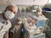 Greyson Leo Phillips sleeps in his incubator about a month after his birth in Brazil, surrounded by his parents and sister.