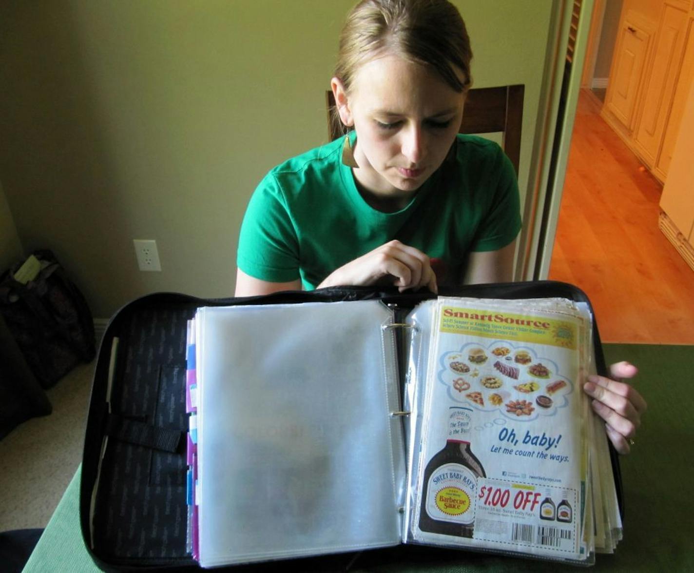 In this photo taken Tuesday, June 28, 2011, Monica Knight, a dental hygienist and mother of two, shows her coupon binder at her home in Boise, Idaho. Knight, a used to spend spent $600 a month on groceries. Thanks to extreme couponing she's down to $100-150 a month.