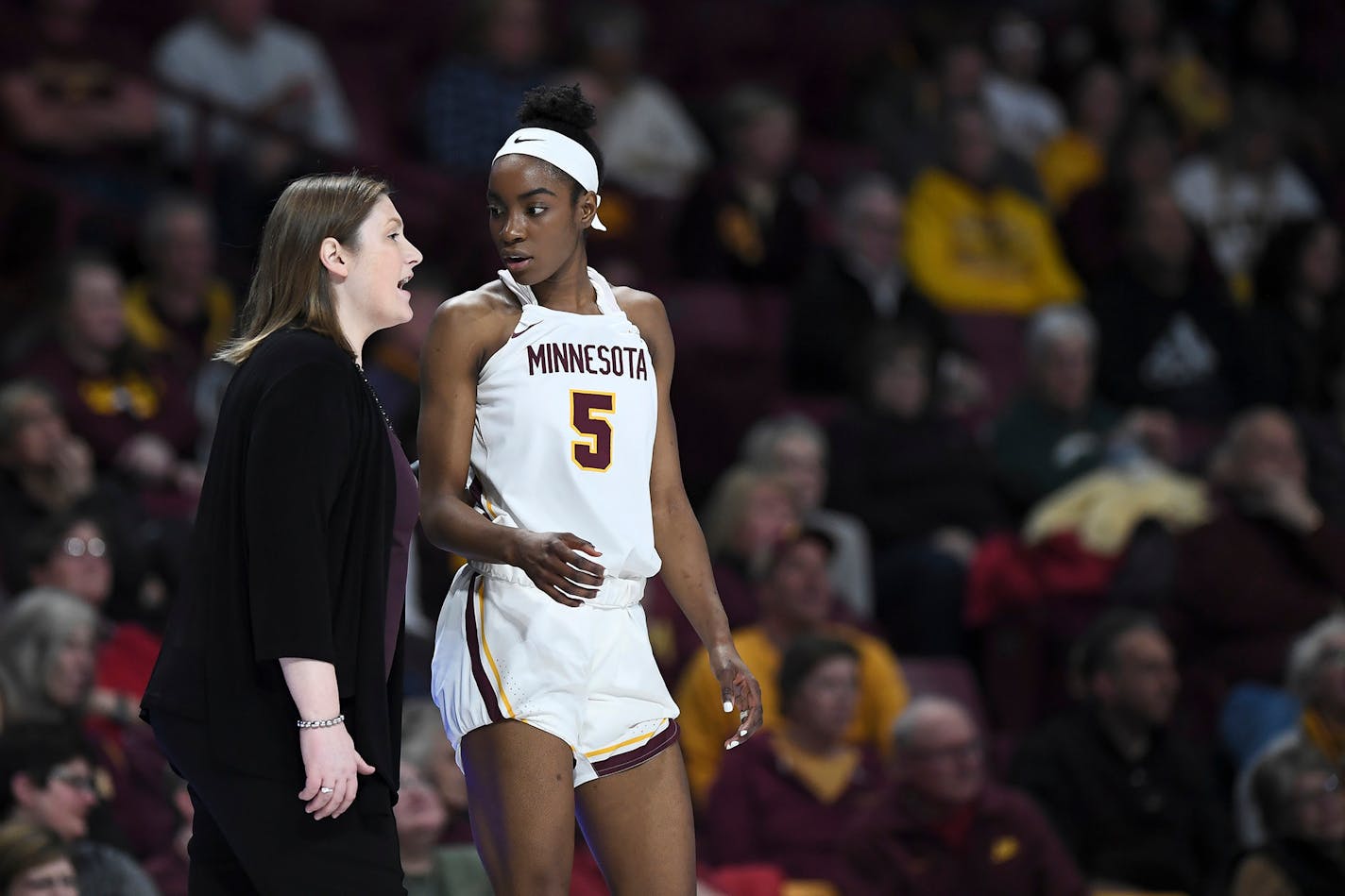 Gophers coach Lindsay Whalen talks things over with forward Taiye Bello in the second half against Iowa during a game in January.